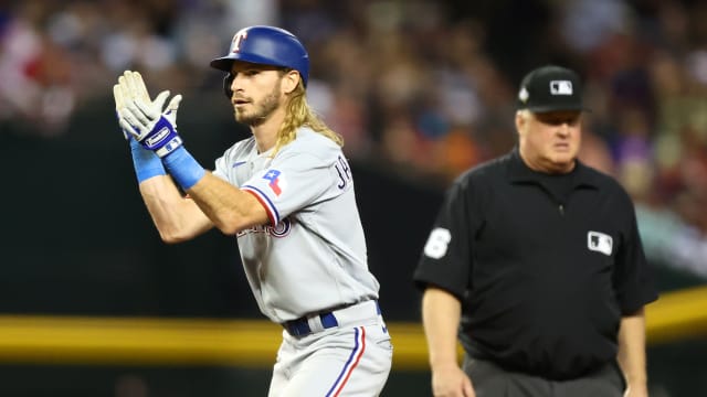 Texas Rangers left fielder Travis Jankowski (16) reacts after hitting a two run double against the Arizona Diamondbacks during the third inning in game four of the 2023 World Series at Chase Field.